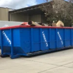 Large roll-off dumpster placed in a residential driveway in Orlando for junk removal.
