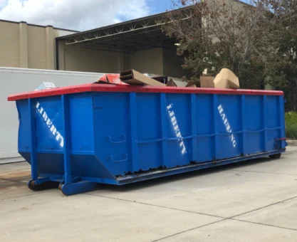 Large roll-off dumpster placed in a residential driveway in Orlando for junk removal.