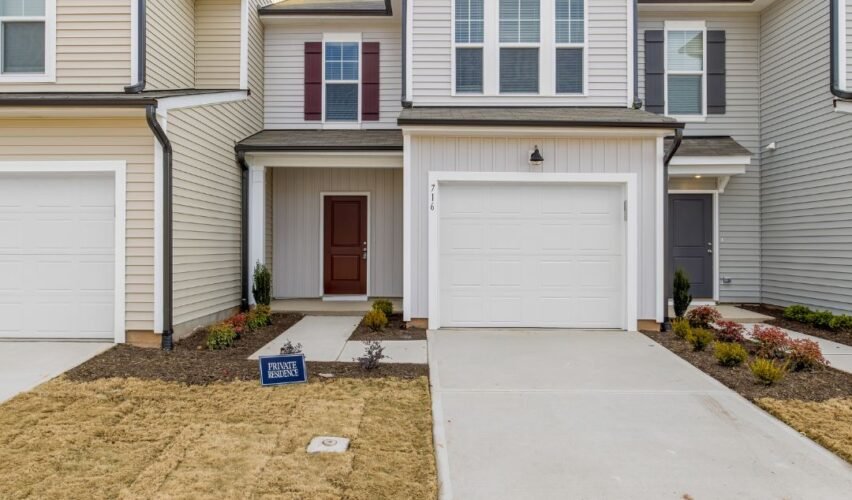 Modern kitchen with white cabinetry, stainless steel appliances, and a cozy home addition with large windows, showcasing a Lake Wylie, SC home remodel.