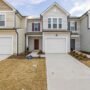Modern kitchen with white cabinetry, stainless steel appliances, and a cozy home addition with large windows, showcasing a Lake Wylie, SC home remodel.
